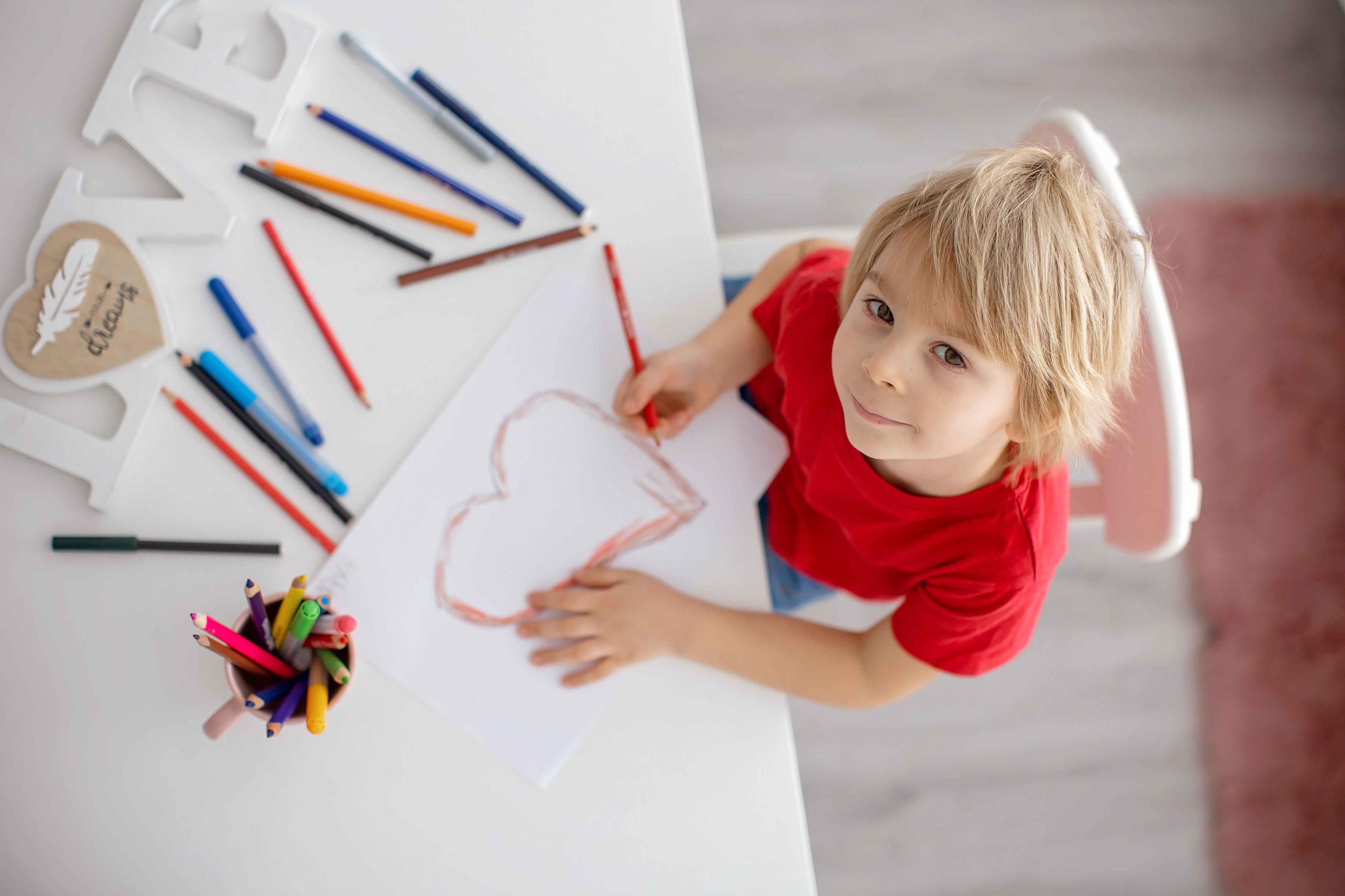 Child drawing heart for Mini Maestro book order